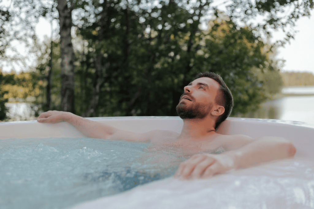 A man relaxes in a hot tub.