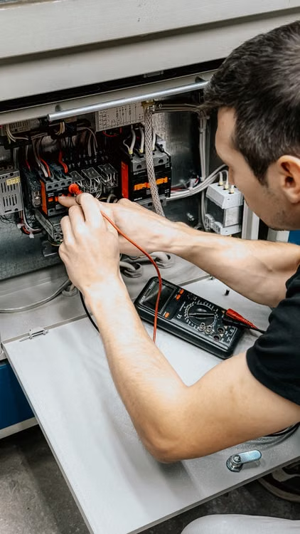 A professional electrician works at home.