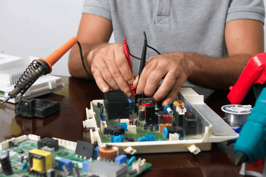 A person works on a DIY electrical repair. 