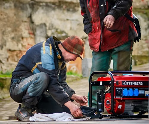 A homeowner checks a generator.