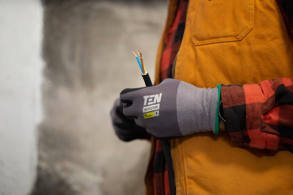 A person holding wires in their hand